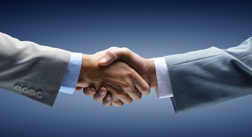 Handshake - Hand holding on black background